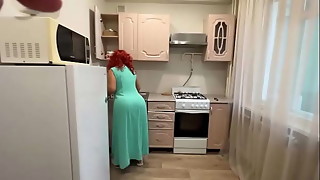 The MILF knelt in front of her son in the kitchen and allowed him to insert a dick in her ass